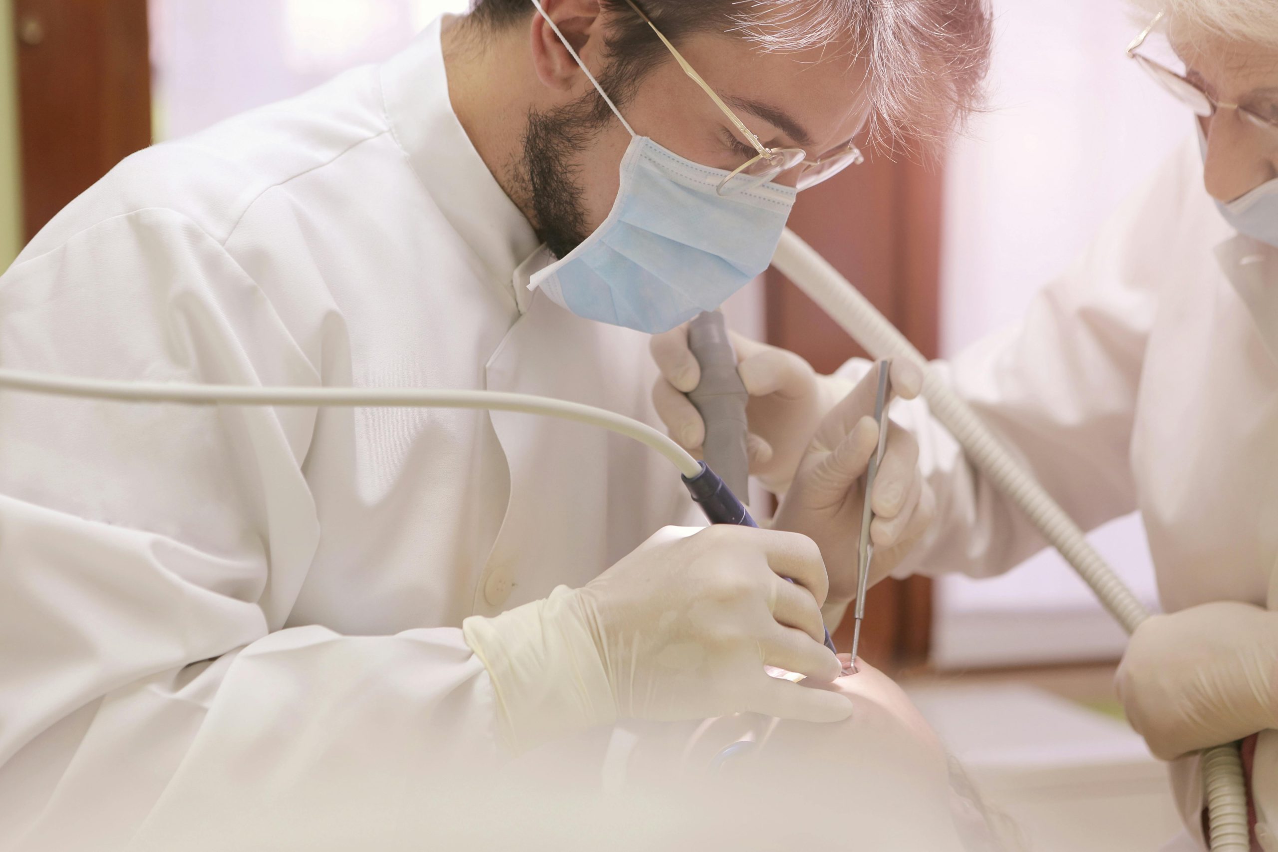 Close-up of a dentist providing dental care to a patient, showcasing precision and professionalism.